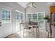 Bright breakfast nook with a wooden table, white chairs, and large windows overlooking the backyard at 2019 Lynmore Dr, Sherrills Ford, NC 28673