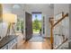 Bright entryway featuring hardwood floors, an open door to the lush outdoors, and a staircase at 2019 Lynmore Dr, Sherrills Ford, NC 28673