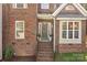 Charming brick home featuring a welcoming front door with wreath and well-maintained landscaping at 2019 Lynmore Dr, Sherrills Ford, NC 28673