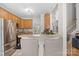 Functional kitchen with a stainless steel fridge, breakfast bar, and views into the living room at 2019 Lynmore Dr, Sherrills Ford, NC 28673