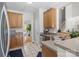 Charming kitchen featuring stainless steel sink, tile flooring, and wood cabinetry at 2019 Lynmore Dr, Sherrills Ford, NC 28673