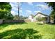 View of the back of the home with a well-maintained lawn and privacy fence on a sunny day at 232 Orange St, Charlotte, NC 28205