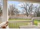 View of expansive backyard from porch, featuring privacy fence and mature trees at 232 Orange St, Charlotte, NC 28205