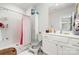 Bathroom features tile floor, tub/shower, and white vanity with storage at 232 Orange St, Charlotte, NC 28205