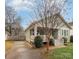 Quaint green home with a welcoming front porch and a private driveway on the side at 232 Orange St, Charlotte, NC 28205