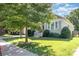 Charming exterior view showcasing a well-maintained lawn, attractive landscaping, and a cozy covered porch at 232 Orange St, Charlotte, NC 28205