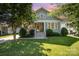 Charming home featuring a landscaped front yard, inviting porch, and mature shade trees at 232 Orange St, Charlotte, NC 28205