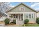 Charming green home with a inviting front porch and well-maintained landscaping at 232 Orange St, Charlotte, NC 28205