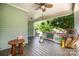 Relaxing front porch featuring ample space, charming decor, and a ceiling fan for comfortable outdoor enjoyment at 232 Orange St, Charlotte, NC 28205