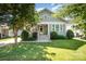 Charming home with a well-manicured lawn, lush landscaping, and a welcoming front porch, perfect for relaxation at 232 Orange St, Charlotte, NC 28205