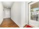 Bright hallway with hardwood floors leads to rooms, while the front door allows plenty of light at 232 Orange St, Charlotte, NC 28205