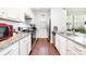 Well-lit kitchen featuring stainless steel appliances, white cabinets, and hardwood flooring at 232 Orange St, Charlotte, NC 28205