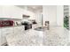 Updated kitchen boasts granite countertops, white cabinets, and stainless steel appliances at 232 Orange St, Charlotte, NC 28205