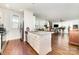Open kitchen to the living room featuring stainless steel appliances, white cabinetry, and hardwood flooring at 232 Orange St, Charlotte, NC 28205
