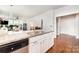 Open-concept kitchen offering granite counters, white cabinetry, and stainless steel dishwasher at 232 Orange St, Charlotte, NC 28205
