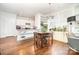 A view of the kitchen and dining space featuring hardwood floors and built in shelves at 232 Orange St, Charlotte, NC 28205