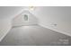 Attic space with neutral carpet, ample lighting, and dormer windows, ideal for storage or conversion into a living space at 2872 Wheat Field Ct, Lincolnton, NC 28092