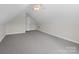 The attic offers a bright area, plush carpeting, and access door, making it a versatile space for various uses at 2872 Wheat Field Ct, Lincolnton, NC 28092