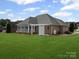 Spacious backyard featuring a brick home with a screened porch and lush green lawn at 2872 Wheat Field Ct, Lincolnton, NC 28092