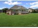 Large backyard with a covered patio, well-maintained lawn, and landscaping at 2872 Wheat Field Ct, Lincolnton, NC 28092