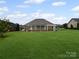 Expansive backyard featuring a screened-in porch and lush green lawn at 2872 Wheat Field Ct, Lincolnton, NC 28092