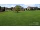 Expansive green backyard featuring a brick home with a screened porch and an ample lawn at 2872 Wheat Field Ct, Lincolnton, NC 28092