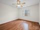 This bedroom features hardwood floors and a ceiling fan, complemented by natural light from the window at 2872 Wheat Field Ct, Lincolnton, NC 28092