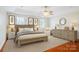 Nicely furnished bedroom showcasing a stylish bed, dresser, accent chair and two windows with shutters at 2872 Wheat Field Ct, Lincolnton, NC 28092