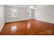 Spacious bedroom features hardwood floors, two windows with plantation shutters and tray ceiling with fan at 2872 Wheat Field Ct, Lincolnton, NC 28092
