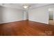 Bright bedroom with hardwood floors, a ceiling fan, and an open doorway to another room at 2872 Wheat Field Ct, Lincolnton, NC 28092