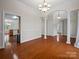 Elegant dining room featuring hardwood floors, white columns, and an open entryway at 2872 Wheat Field Ct, Lincolnton, NC 28092