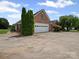 Long driveway with a two car garage, mature trees, and manicured lawn at 2872 Wheat Field Ct, Lincolnton, NC 28092