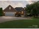 Brick home with a two-car garage and manicured lawn at 2872 Wheat Field Ct, Lincolnton, NC 28092