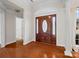 Welcoming foyer with a wooden front door and gleaming hardwood floors at 2872 Wheat Field Ct, Lincolnton, NC 28092