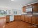 Kitchen featuring wooden cabinets, a white dishwasher, and ample counter space at 2872 Wheat Field Ct, Lincolnton, NC 28092