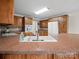 Bright kitchen with a white sink, wooden cabinetry, and ample counter space for meal preparation at 2872 Wheat Field Ct, Lincolnton, NC 28092