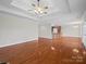 Open concept living room with hardwood floors and tray ceiling leading to kitchen at 2872 Wheat Field Ct, Lincolnton, NC 28092
