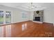 Spacious living room with hardwood floors, stone fireplace, and a ceiling fan at 2872 Wheat Field Ct, Lincolnton, NC 28092