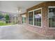 Covered brick patio with ceiling fan and views of the backyard at 2872 Wheat Field Ct, Lincolnton, NC 28092