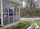 Enclosed back porch featuring latticework and an outdoor living space, with a snowy backyard view at 2942 Reid Ave, Charlotte, NC 28208