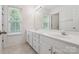 Bathroom featuring a double vanity, large mirror, and a window for natural light at 3043 Streamlet Way, Monroe, NC 28110