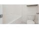 Clean white bathroom with a tub and toilet, plus a small wooden shelf at 3043 Streamlet Way, Monroe, NC 28110