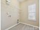 Walk-in closet featuring installed shelving, a window, and laminate floors at 3043 Streamlet Way, Monroe, NC 28110