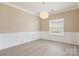Bright dining room featuring modern lighting, paneling details, and neutral color palette at 3043 Streamlet Way, Monroe, NC 28110