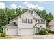 Charming two-story home with lush landscaping and a three-car garage at 3043 Streamlet Way, Monroe, NC 28110