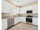 Well-equipped kitchen with stainless steel appliances, white cabinets and tile flooring at 3043 Streamlet Way, Monroe, NC 28110