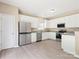 Spacious kitchen with stainless steel appliances and white cabinets at 3043 Streamlet Way, Monroe, NC 28110