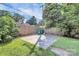 Gated parking area for vehicles and storage, featuring lawn and mature trees at 323 Keswick Ave, Charlotte, NC 28206