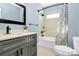 Charming bathroom with a dark vanity, modern fixtures, and a shower-tub combo with stylish curtain at 323 Keswick Ave, Charlotte, NC 28206