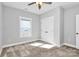 This bedroom features a ceiling fan, a window for natural light, and a double-door closet for ample storage at 323 Keswick Ave, Charlotte, NC 28206